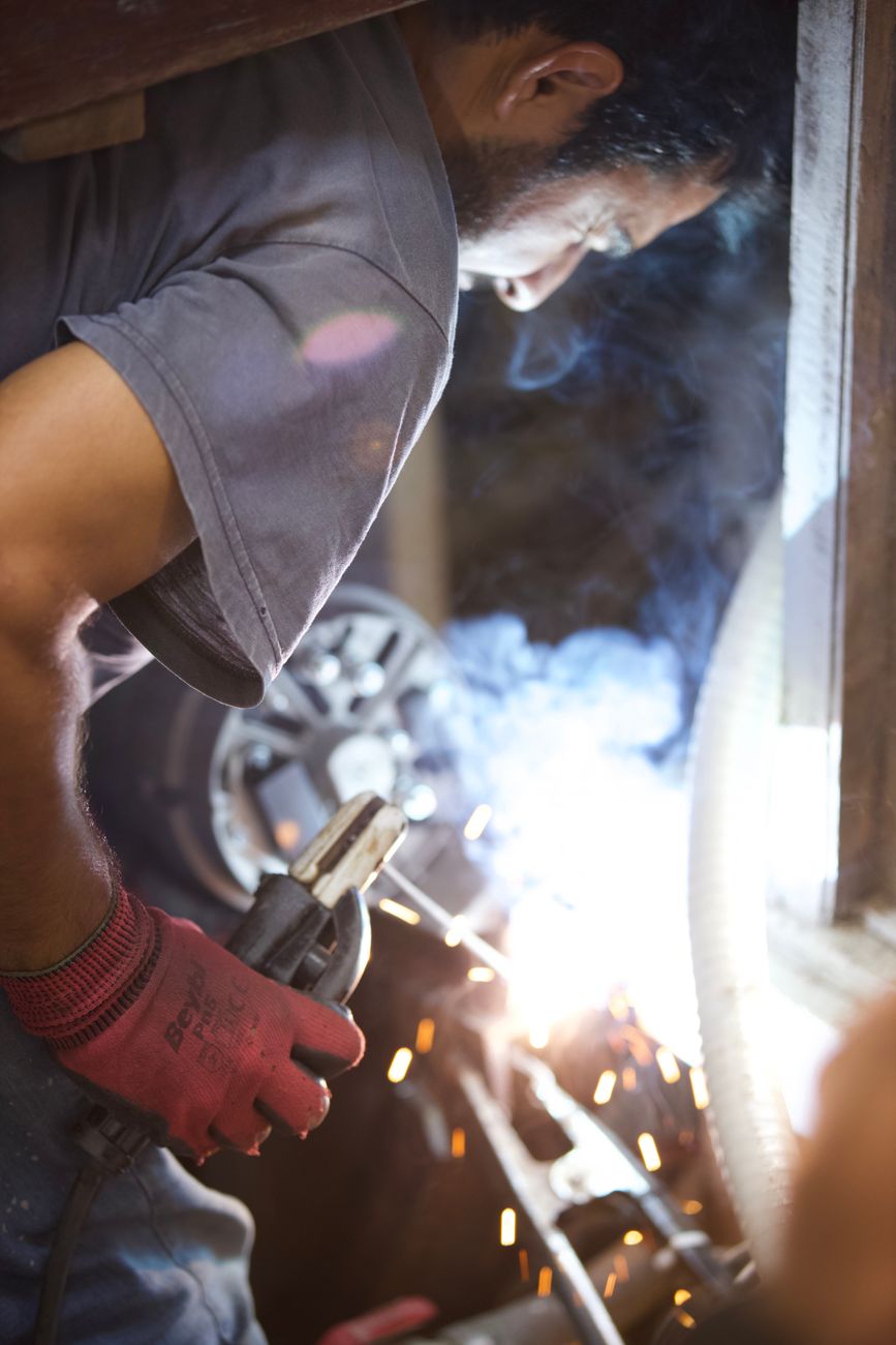 photo of a man welding